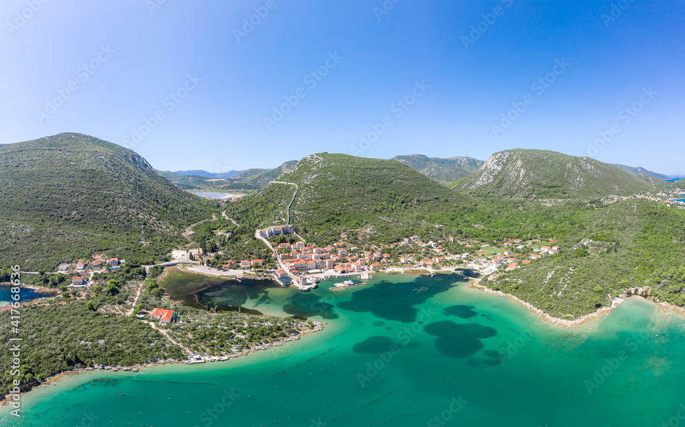 Aerial drone shot of Mali Ston village with City Wall of Ston in Ragusa near Dubrovnik in Croatia summer