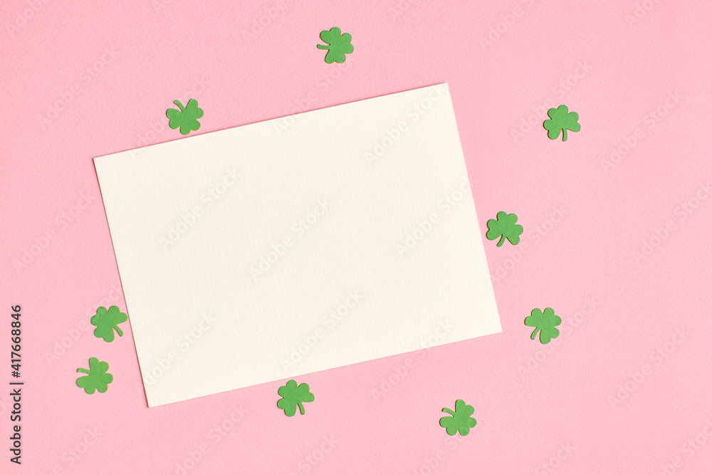 Saint Patricks day greeting card mockup with paper shamrock on pink background