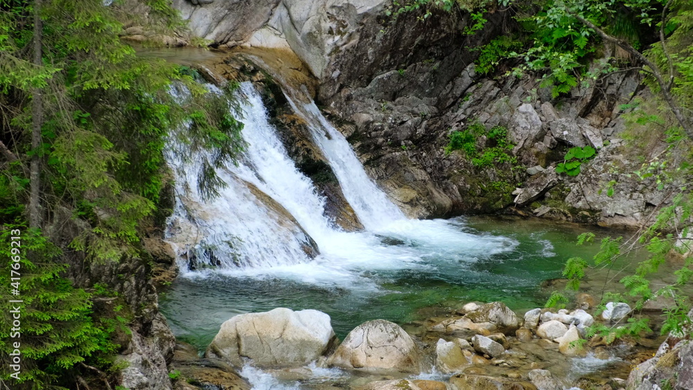 mountain waterfall flowing on the rocks mountain waterfall flowing on the rocks