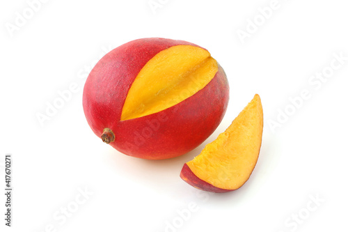 Cut mango with a slice isolated on white