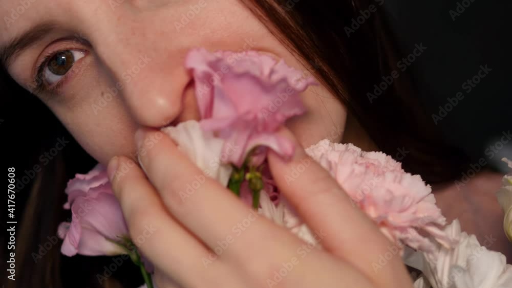 Pretty young woman enjoys a bouquet of fresh flowers. A calm and peaceful woman sniffs flowers and enjoys life. Holiday concept 8 march, love day, mother's day Pretty young woman enjoys a bouquet of fresh flowers. A calm and peaceful woman sniffs flowers and enjoys life. Holiday concept 8 march, love day, mother's day