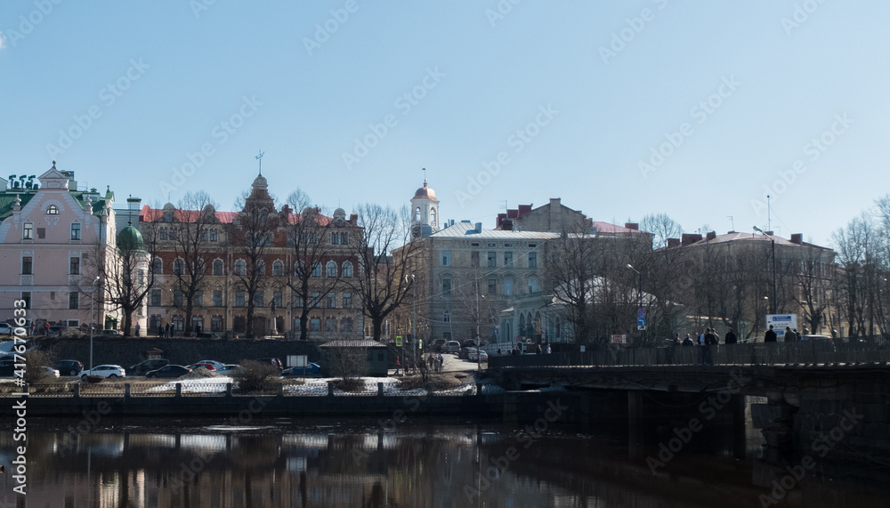 Beautiful houses and a bridge over the river. Vyborg city, Russia. The oldest city that used to belong to Finland and Sweden. Bridge over the river. Beautiful architecture and outbuildings.