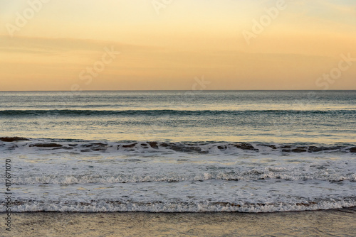  wave at sea breaking on the beach  in a quiet sunrise  with the sea calm