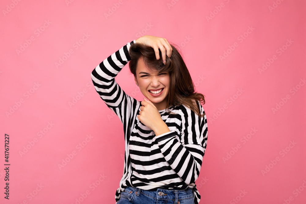 Portrait of positive cheerful fashionable woman in casual clothes isolated on pink background with copy space Portrait of positive cheerful fashionable woman in casual clothes isolated on pink background with copy space