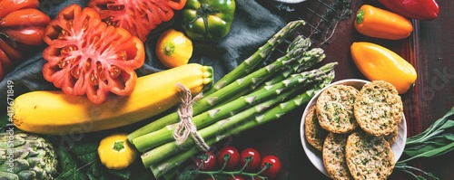 Composition with raw vegetables asparagus and ox heart tomatoes