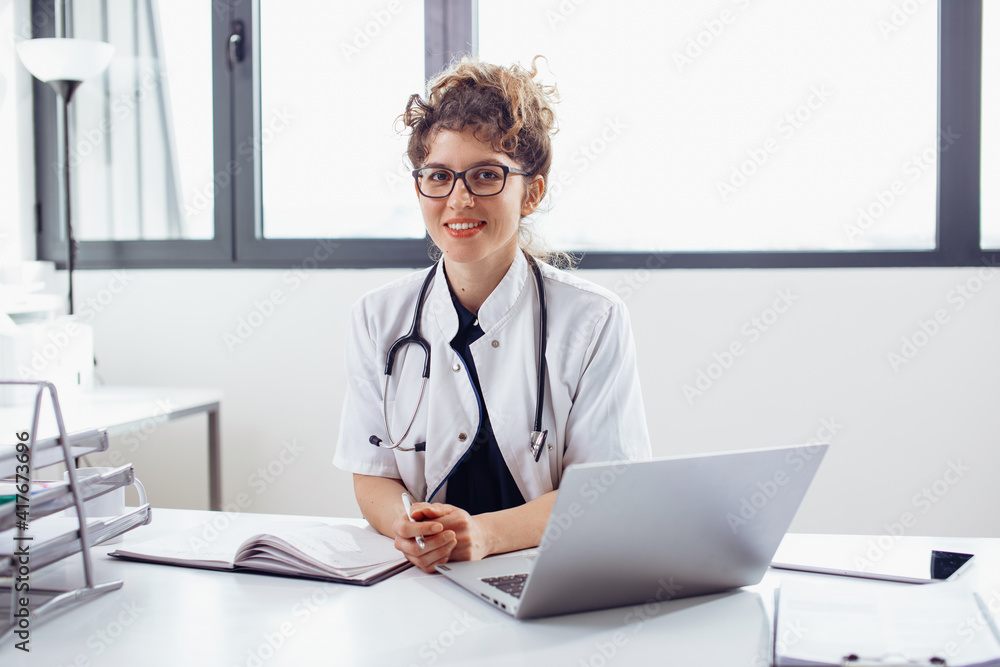 Young female doctor at doctor’s office. Portrait of female doctor. Young female doctor at doctor’s office. Portrait of female doctor.