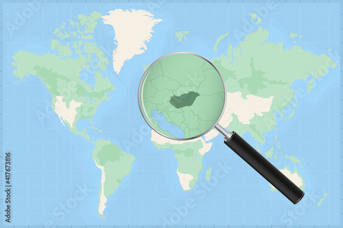 Map of the world with a magnifying glass on a map of Hungary.