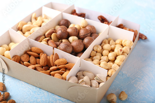 Different grade of nuts in a box on a light background