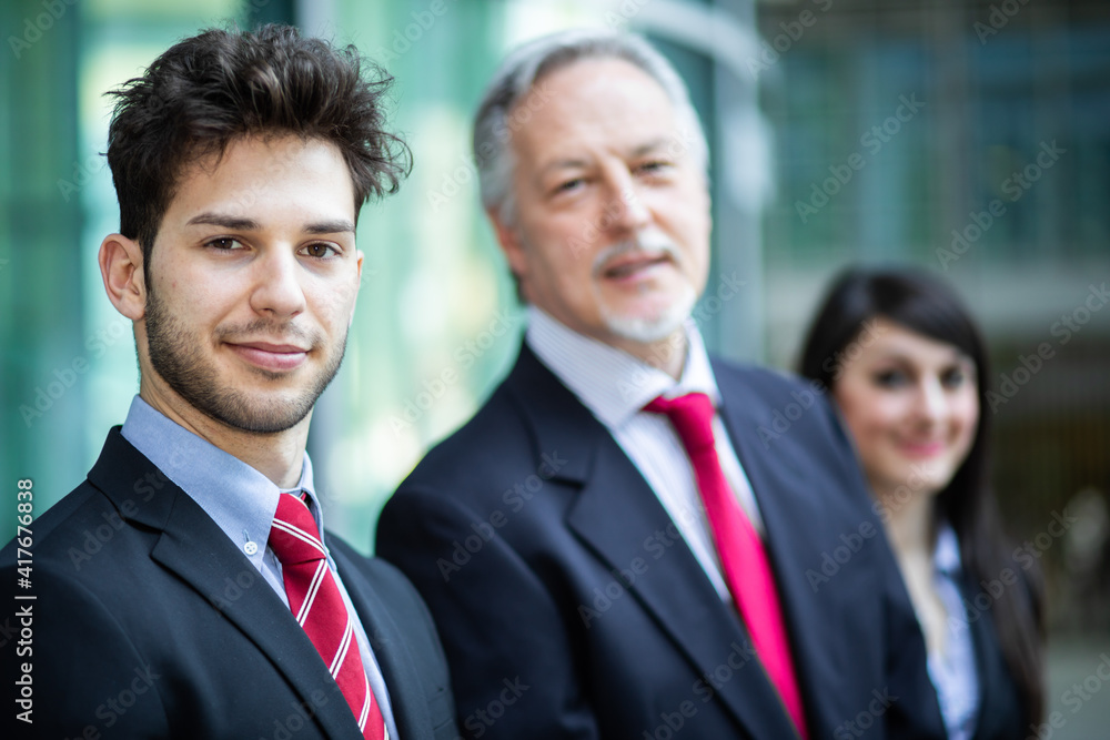 Business team smiling outdoor in a modern urban setting Business team smiling outdoor in a modern urban setting