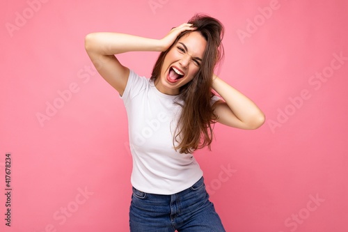 Photo shot of cute nice charming gorgeous attractive pretty youngster emotional and crazy woman wearing white t-shirt for mockup isolated over colorful background with copy space