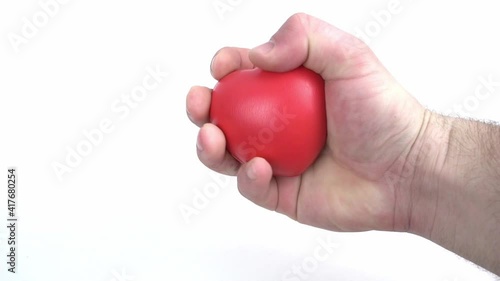 A young man works with a red hand expander on a white background photo