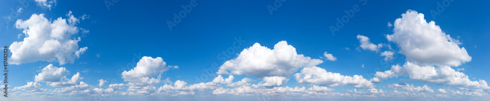 Panoramic fluffy cloud in the blue sky. Sky with cloud on a sunny day. Panoramic fluffy cloud in the blue sky. Sky with cloud on a sunny day.