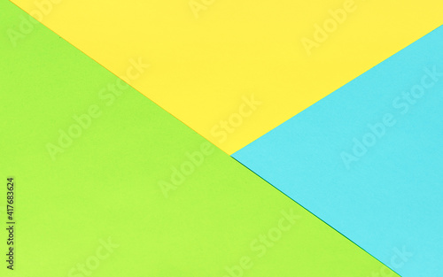 Yellow blue and green color paper geometric flat lay colorful background