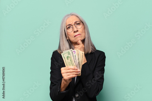 ysenior pretty businesswoman with dollar banknotes. money concept photo