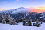 A panoramic view. Winter. Amazing sunrise. Landscape of high mountains with snow white peaks and forests. Aerial view. Wallpaper background. Natural scenery. Location place Carpathian, Ukraine, Europe