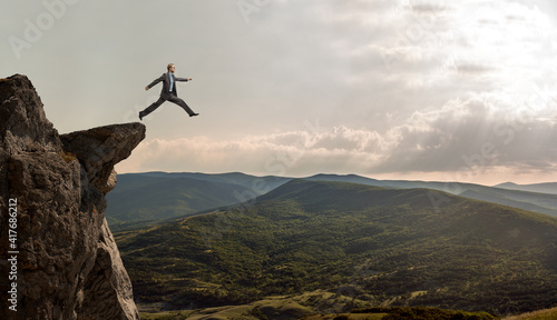 businessman walks through an abyss