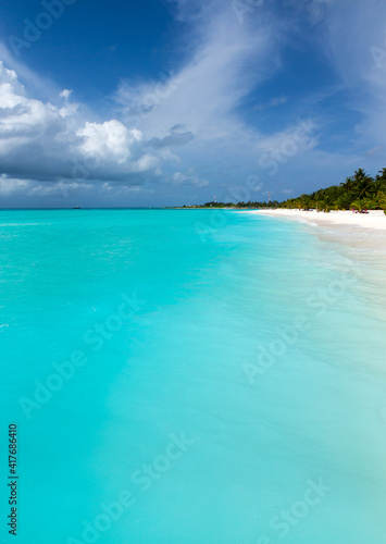 tropical Maldives island with white sandy beach and sea