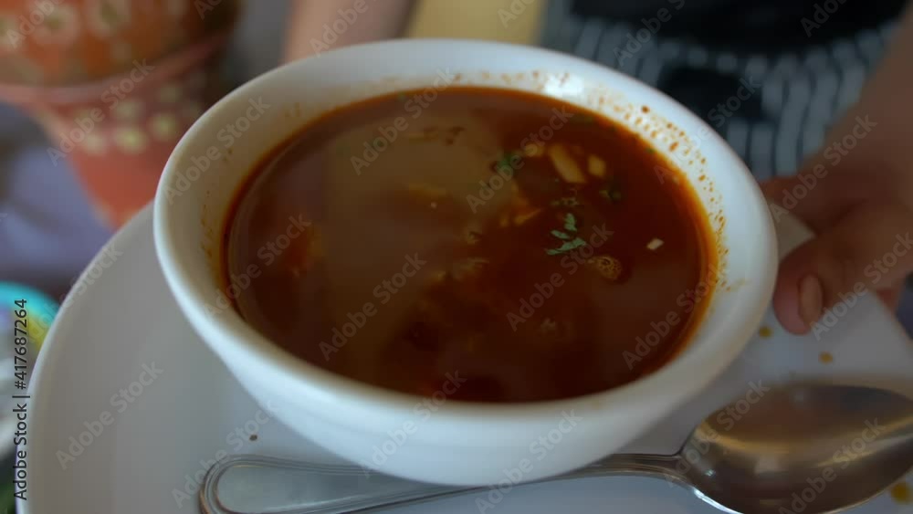 Cook holding a bowl of hot beef stew Cook holding a bowl of hot beef stew