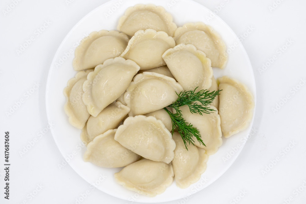 Boiled dumplings with potatoes. Traditional Ukrainian and Russian food. White background. Boiled dumplings with potatoes. Traditional Ukrainian and Russian food. White background.