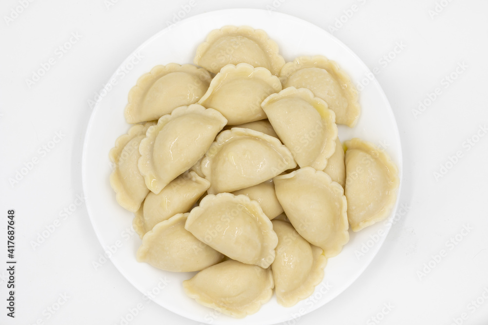 Boiled dumplings with potatoes. Traditional Ukrainian and Russian food. White background.