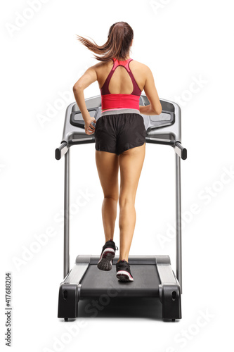 Full length rear shot of a fit female running on a treadmill