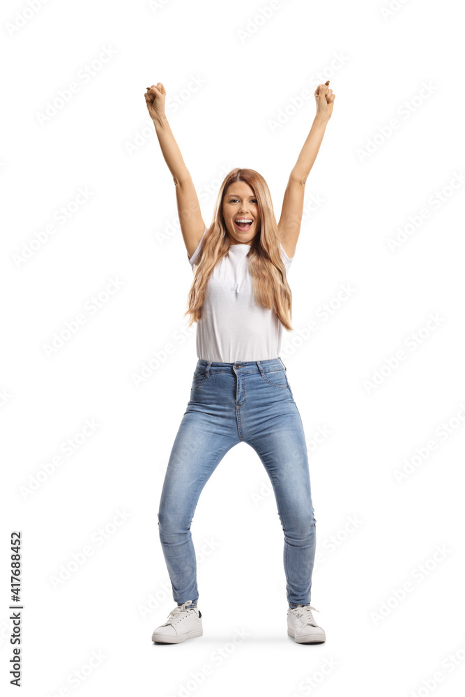 Full length portrait of a casual young woman gesturing happiness with raised arms Full length portrait of a casual young woman gesturing happiness with raised arms