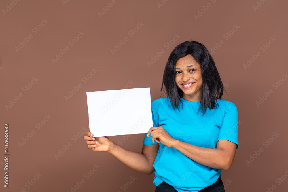 excited beautiful young african woman holding an empty sign, advertising concept