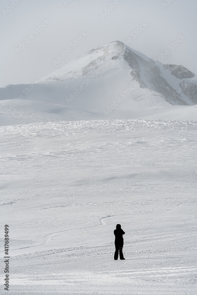 Arcasar Ridge. The Arkhyz Mountains in Karachay-Cherkessia. A snow-white winter landscape and a lonely man. Man and mountain.