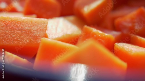 Close-up of chopped pieces of fresh and ripe papaya
