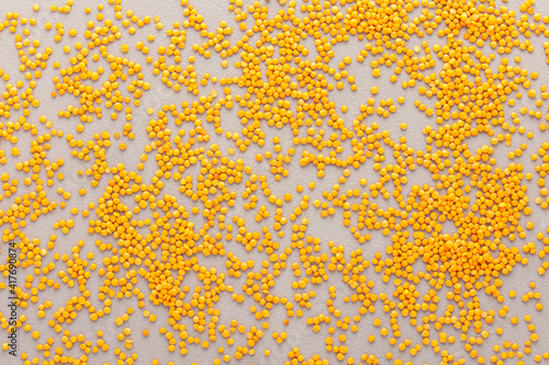 Legumes are scattered in the background, natural background of lentils, top view