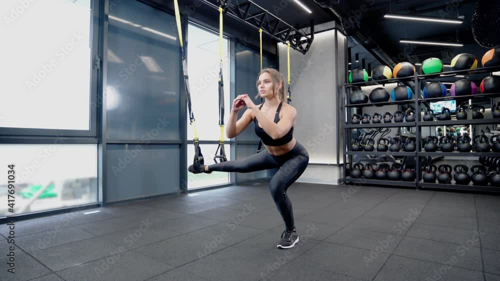Young cute woman squatting on one leg. Young cute woman squatting on one leg.