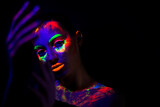 trendy neon makeup on the model. Woman with ultraviolet make-up. Disco night club chameleon. UV colors. Fashion of the future bright appearance. face Art. Copy space for text background
