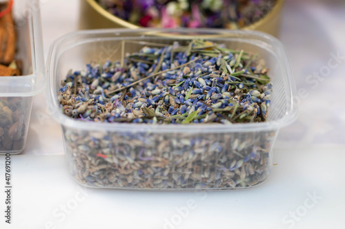 Obraz na plátně The buds of dried blue lavender flowers lie in a plastic box