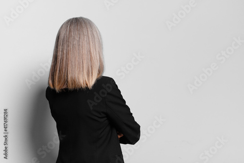 senior businesswoman back view. looking or thinking concept photo