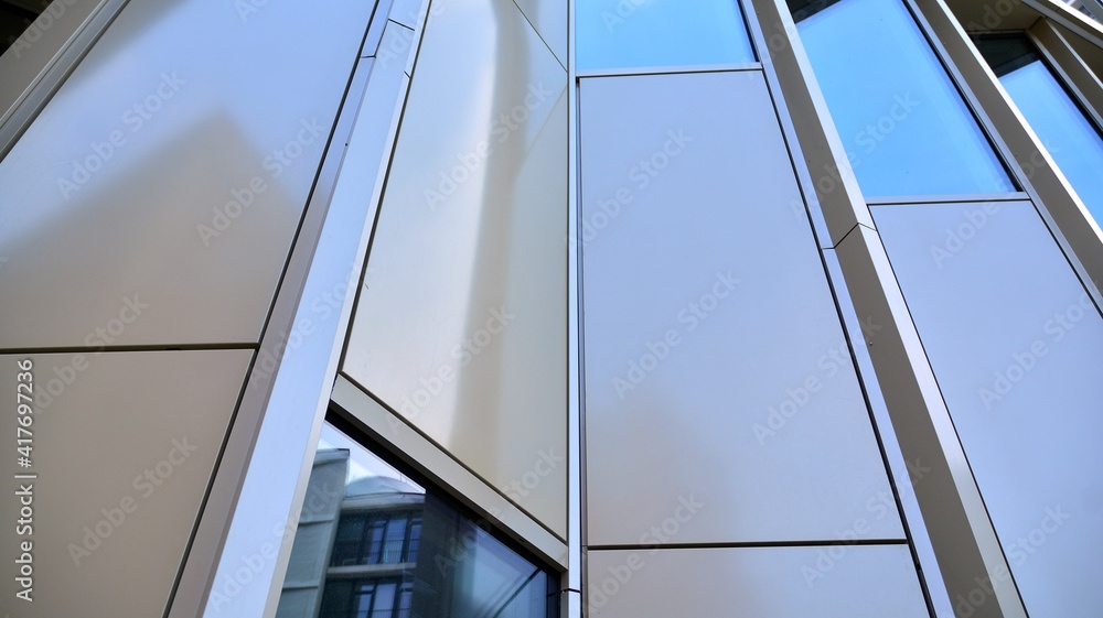 Obraz premium Fragment of glass and metal facade walls. Commercial office buildings. Abstract modern business architecture.
