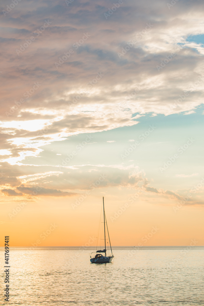 view of sail boat on sunset in bay. summer vacation