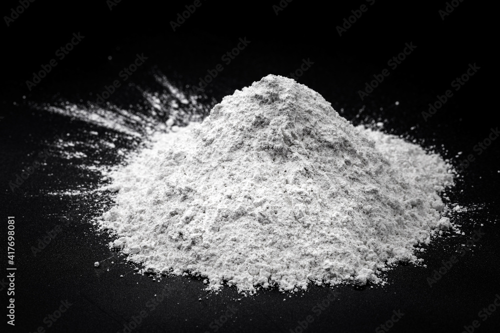 Zinc iodide or Zn2 iodide, white powder. Chemical compound of zinc and iodine on pure black background