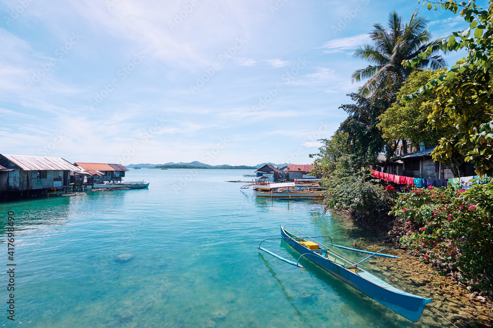 Beautiful landscape with blue sea, tropical islands and fishing houses on stilts in mangrove lagoon, Siargao Island, Philippines.