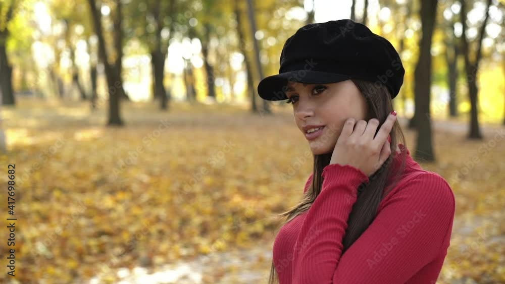 Young brunette in beret posing and flirting at camera in sunny, autumn park Young brunette in beret posing and flirting at camera in sunny, autumn park