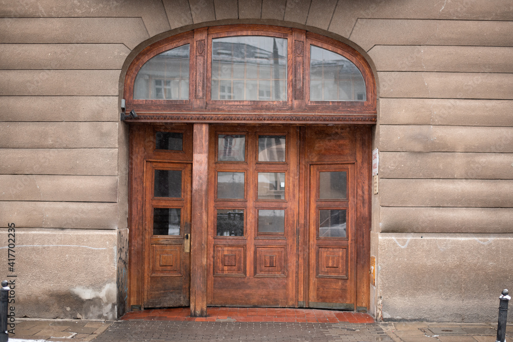 Fototapeta premium Facade old stone wall with door gate