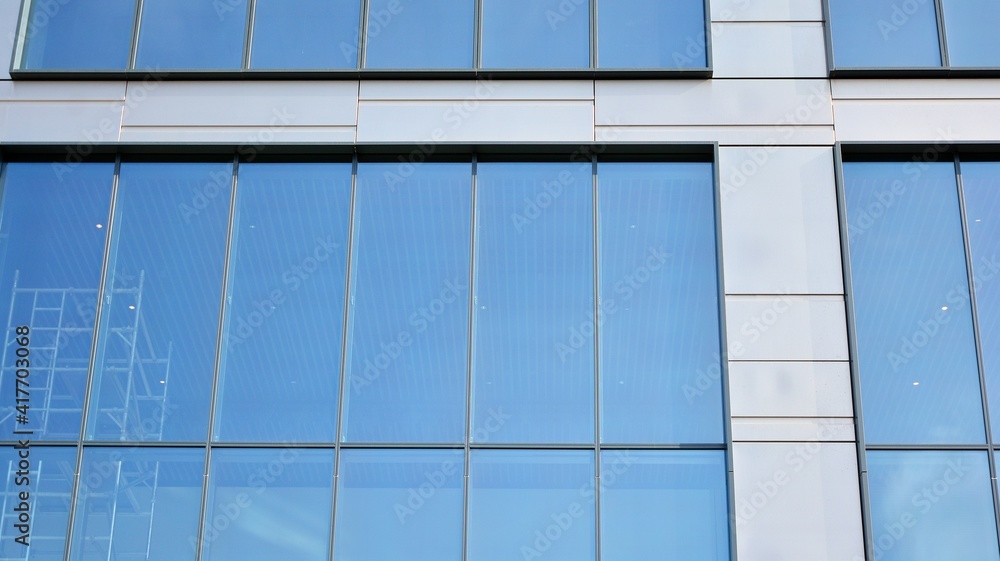 Fragment of glass and metal facade walls. Commercial office buildings. Abstract modern business architecture. Fragment of glass and metal facade walls. Commercial office buildings. Abstract modern business architecture.