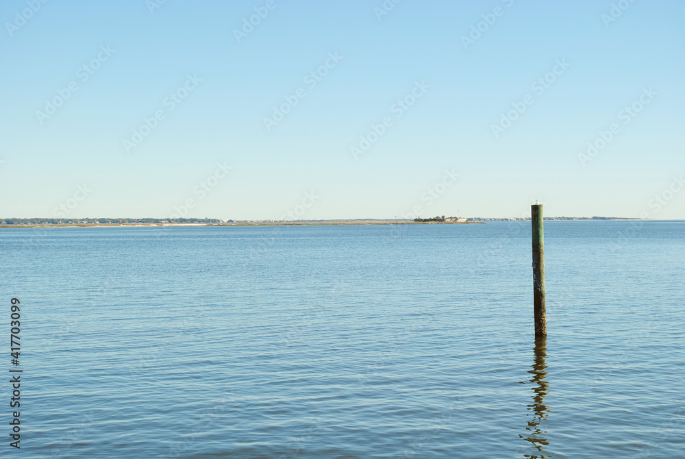 single pier column alone in the harbor