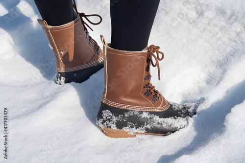 close up of womans boots in the snow photo