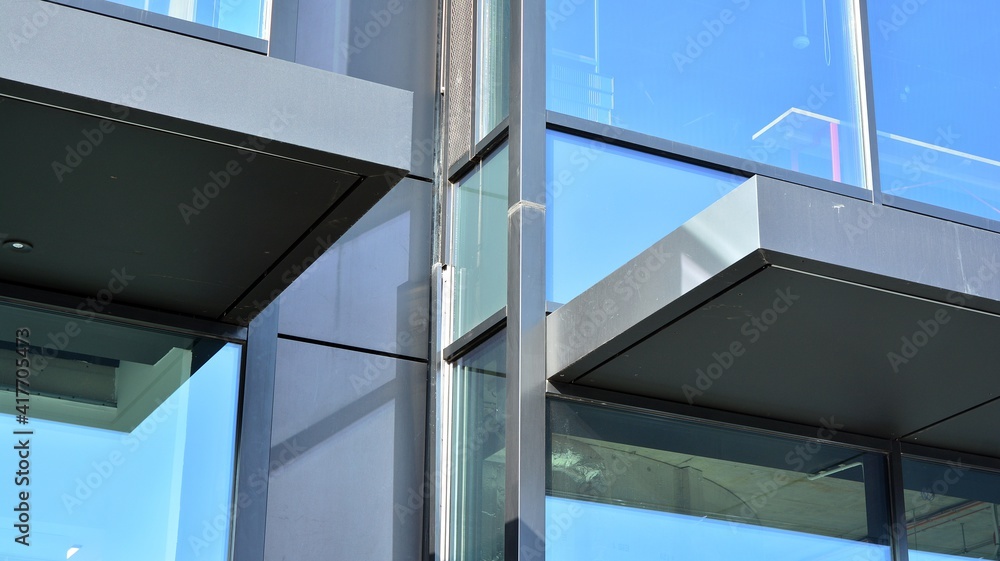 Fragment of glass and metal facade walls. Commercial office buildings. Abstract modern business architecture. Fragment of glass and metal facade walls. Commercial office buildings. Abstract modern business architecture.