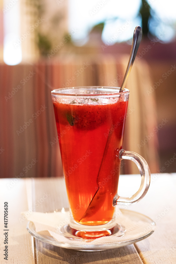 Fruit tea with strawberries on a wooden table Fruit tea with strawberries on a wooden table