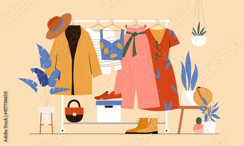 Clothes hanger, garment rack, showroom and clothing organization concept. Clothes, hangers, shoes, bags.