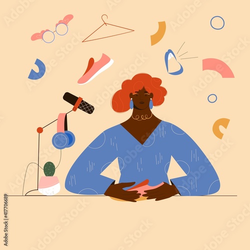 Podcast or radio concept about style, clothes and fashion. Female afro american host talking about fashion, microphone and headphones set, fashion symbols