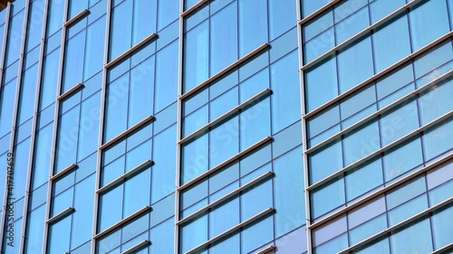 Fragment of glass and metal facade walls. Commercial office buildings. Abstract modern business architecture.