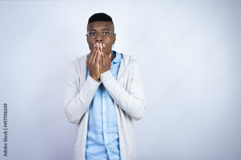 Young handsome african american man wearing casual clothes shocked covering mouth with hands for mistake. secret concept. Young handsome african american man wearing casual clothes shocked covering mouth with hands for mistake. secret concept.
