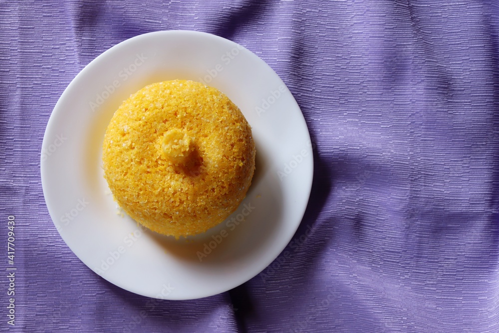 Brazilian Couscous on purple background. Corn couscous. Brazilian food. Brazilian Couscous on purple background. Corn couscous. Brazilian food.